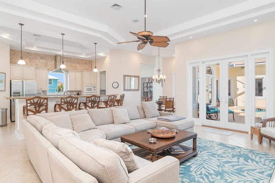 Living room, kitchen, dining room and doorway leading to the pool