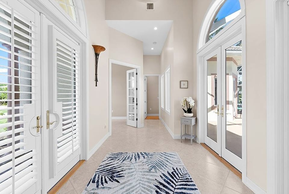 Front door pool view and left wing hallway to twin bedroom and master bedroom