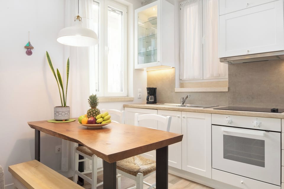 "Prepare delicious meals in our fully equipped kitchen, complete with a dining table for four."