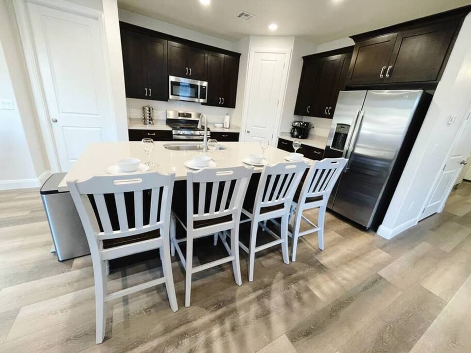 The fully stocked kitchen seats 4 at the bar and 8 at the counter height dining table. 