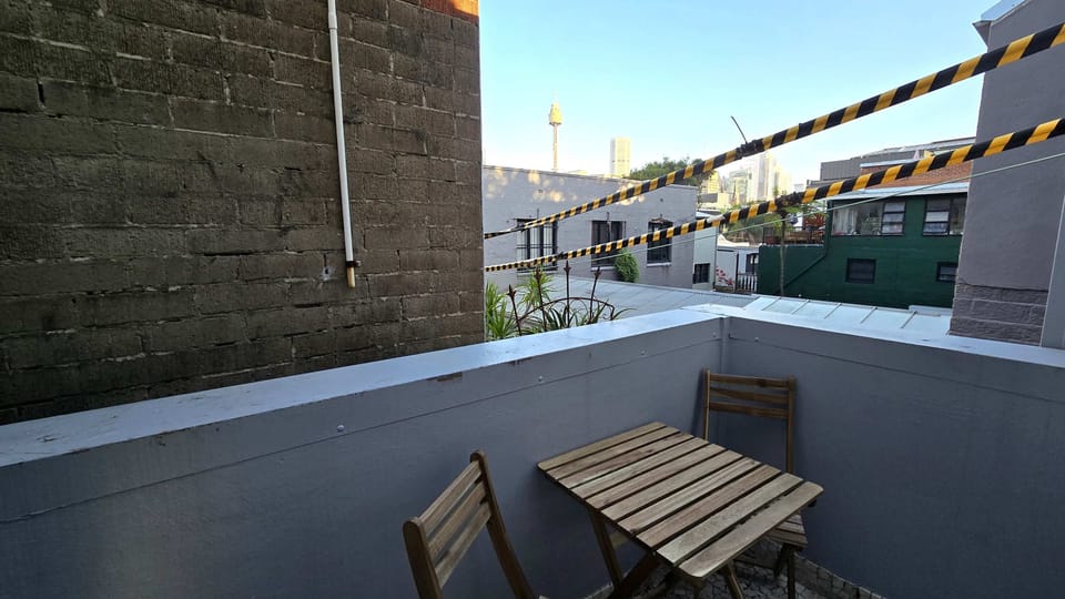 Small balcony with seating for two off the second bedroom