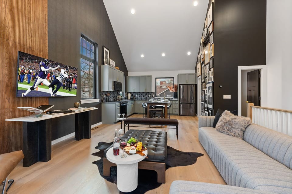 3rd Floor: Bright open living space featuring smart flat-screen TV, designer furnishings, and access to a private balcony with spectacular views of Downtown Nashville.