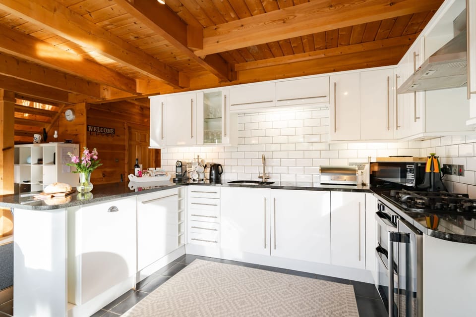 Hillview, Little Petherick, Padstow. Ground floor: The sleek kitchen comes complete with a gas hob, electric oven, fridge/freezer, coffee machine, microwave, dishwasher and washer/dryer