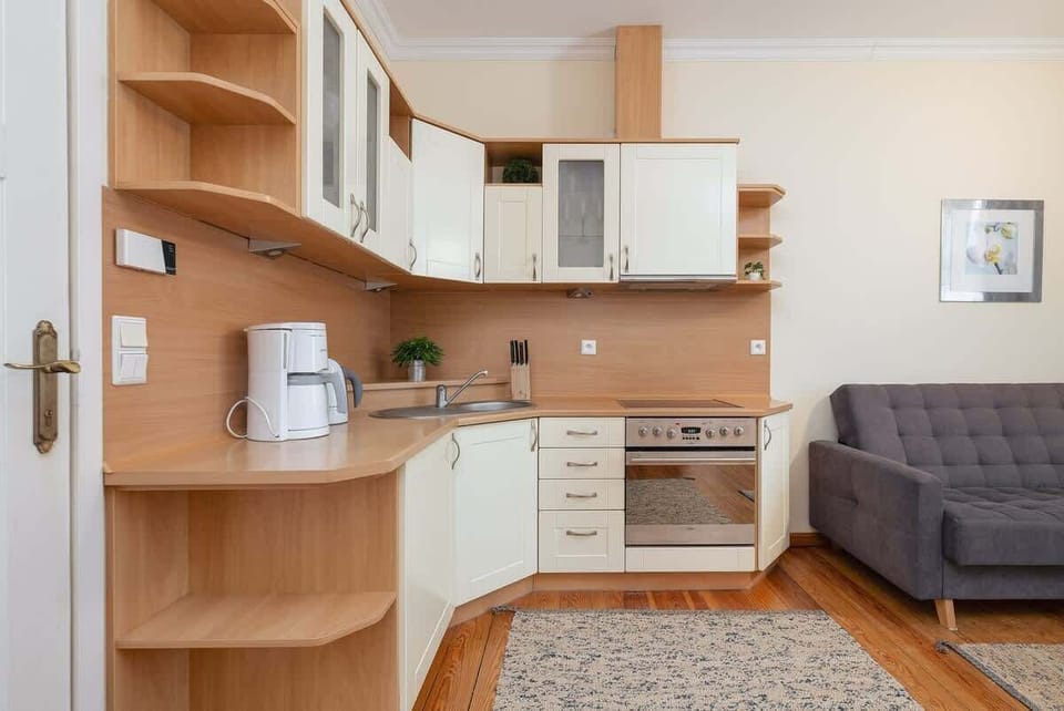 A well-equipped kitchen with wooden cabinets, a built-in oven, and a gas stove. The functional layout makes meal preparation easy and enjoyable.