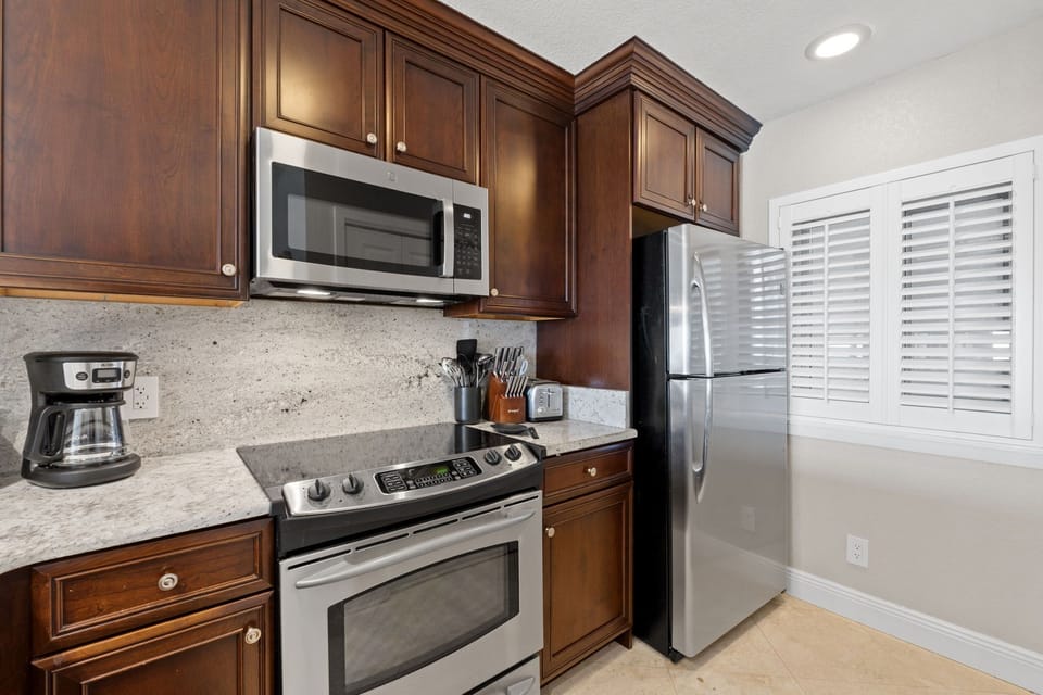 Cook, dine, and gather with panoramic Gulf views from the kitchen.