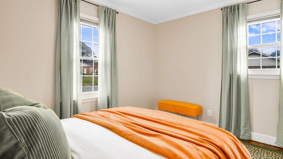 Bedroom with 2 windows and sheer curtains