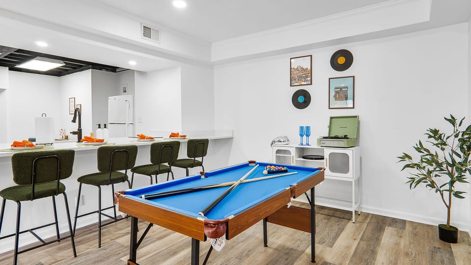 living room 2 with pool table and turn table and kitchen island with 4 seats