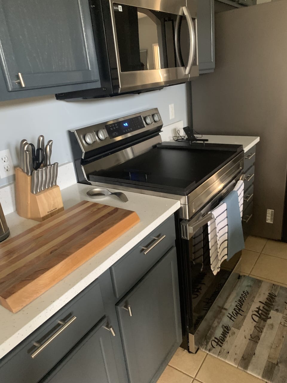 Open Concept Kitchen with Stove/Refrigerator/Microwave and Utensils 