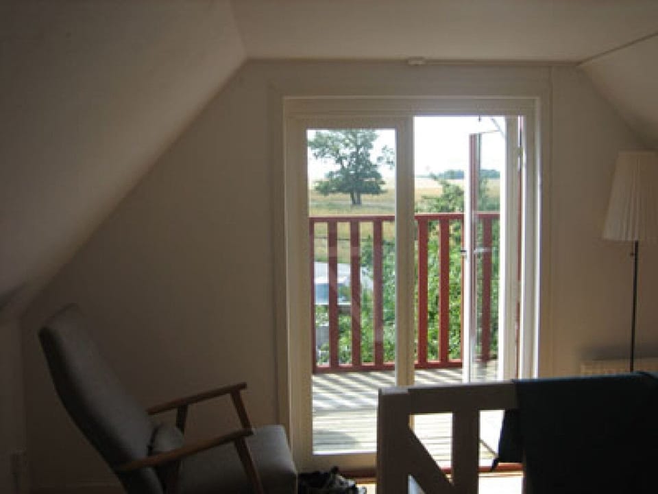 to the balcony fo the smaller house