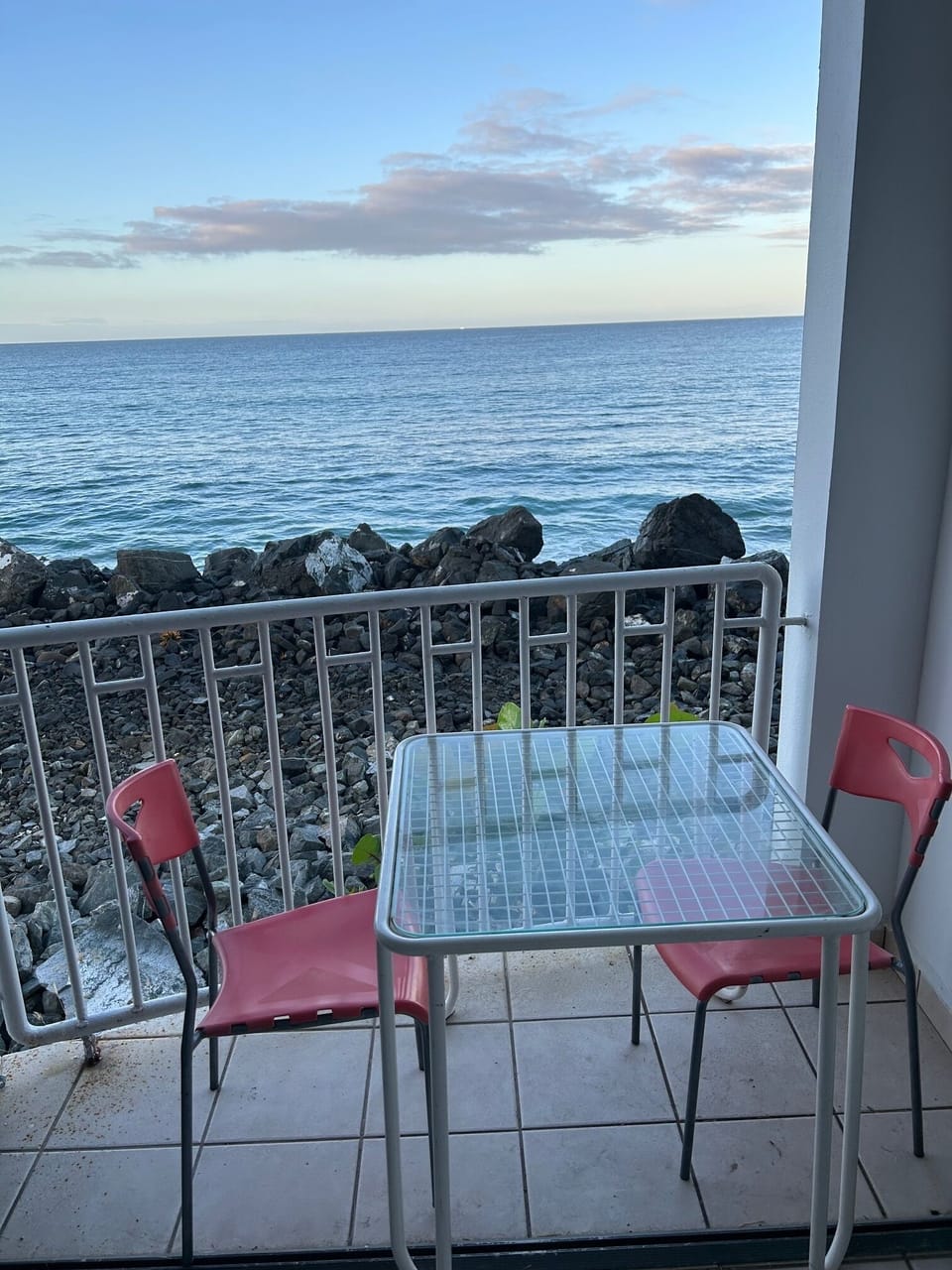 The balcony is close enough to hear the ocean waves