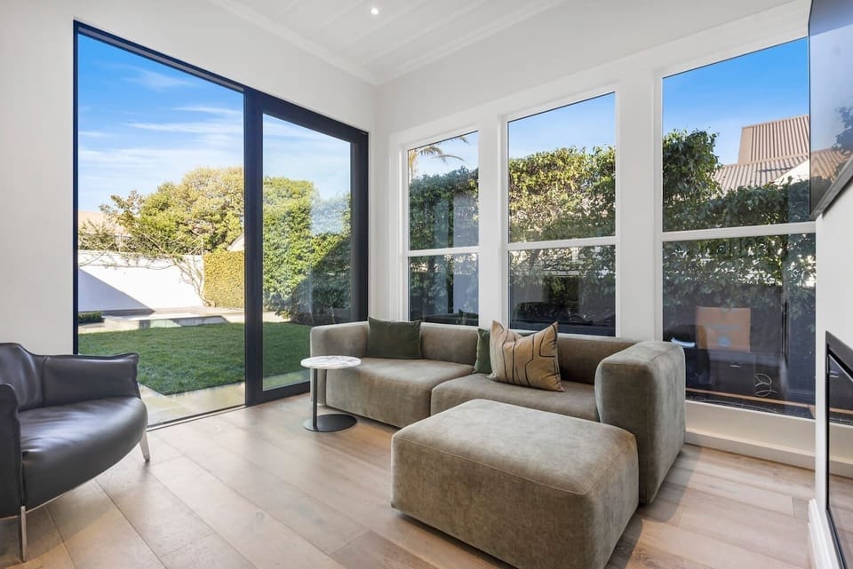 Open plan Living area looking out onto Lawn and pool 