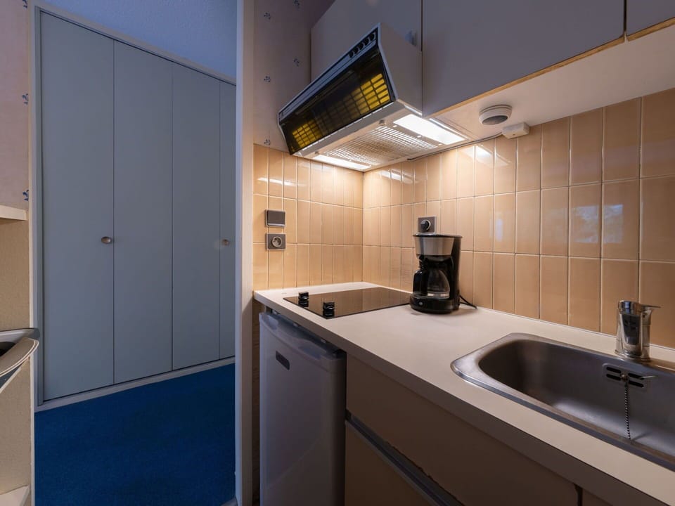 Interior Design, Flooring, Floor, Room, Ceiling, Countertop, Kitchen, Cabinetry, Major Appliance, Apartment