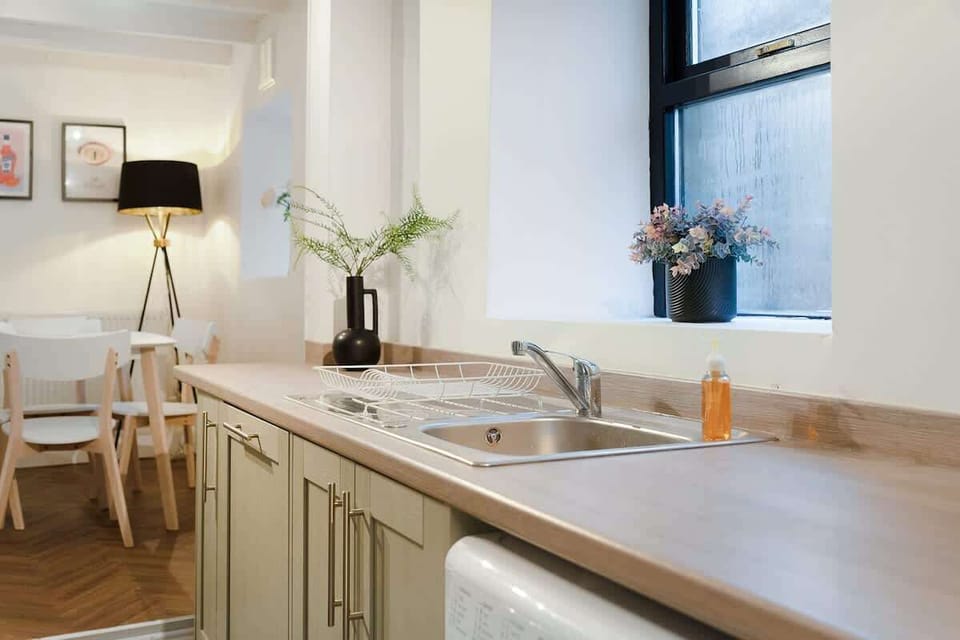 Kitchen equipped with all essentials, including a washer & dryer, oven, fridge and full cookware set.