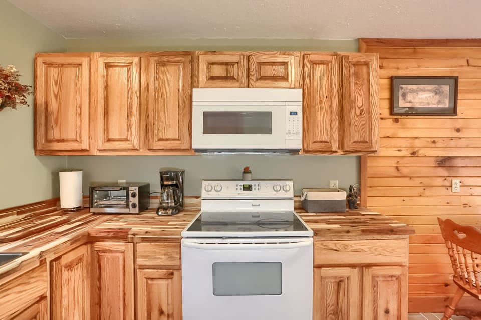 Well-equipped kitchen with toaster oven, coffee pot, keurig (not in photo) & microwave.