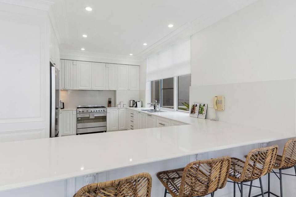 The kitchen features four wicker bar stools to grab a quick bite to eat before hitting the beach.

