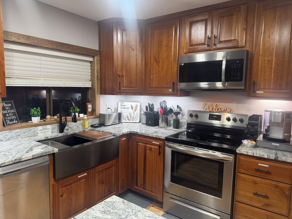 Stove/oven. Microwave vent-a-hood. Cuisinart coffee pot.