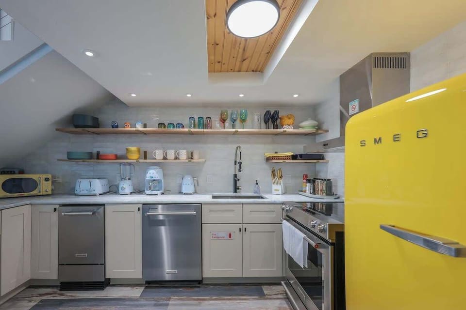 Luxury appliance lineup: iconic Smeg style paired with KitchenAid performance  a gorgeous, high-end kitchen made for both cooking and showing off.