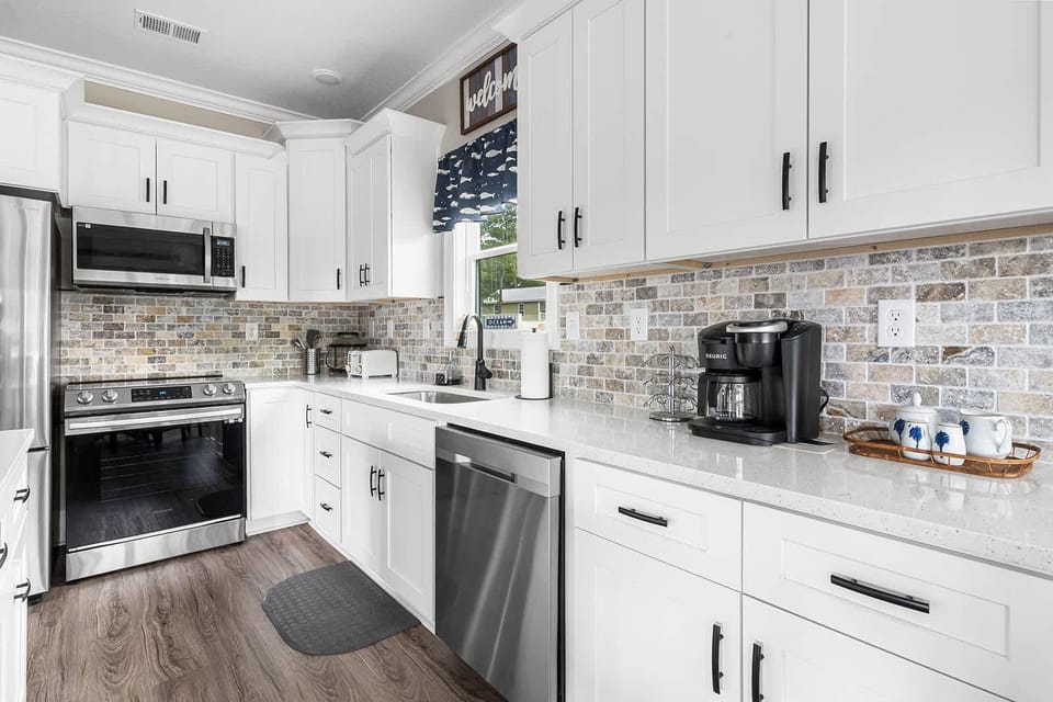 Bright, modern kitchen with stainless steel appliances and cozy window nook