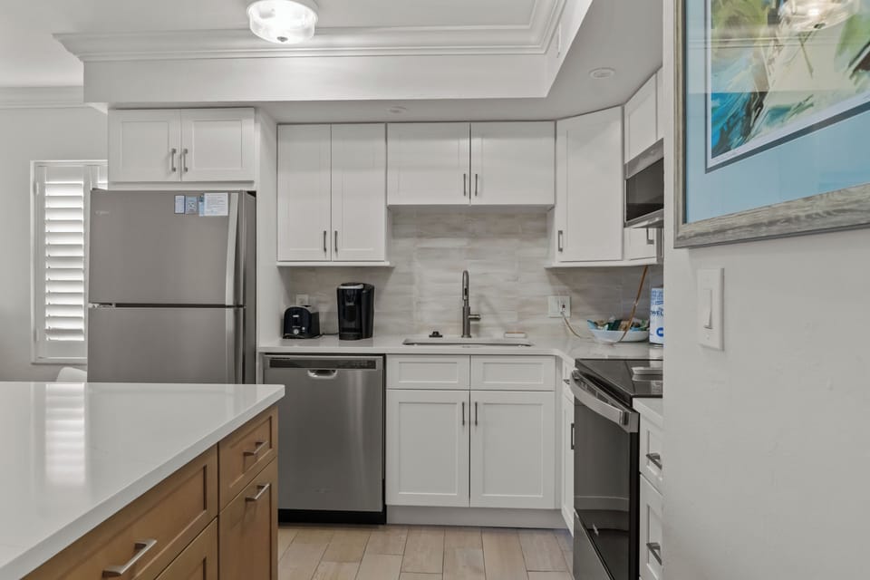Full refrigerator, dishwasher and large sink along with a fully stocked kitchen 