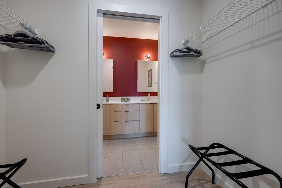 Primary Bedroom - "Jolene" Room featuring a King Bed with a clothing dresser, walk-in closet, Smart TV and an ensuite Primary Bathroom.