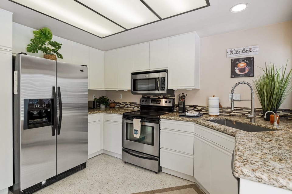 Open spacious kitchen with stainless steel appliances