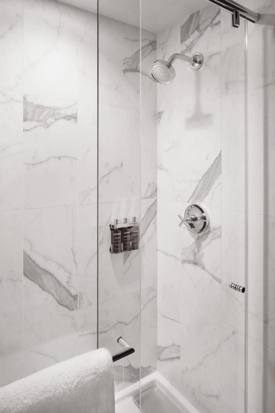 Refresh in a bright marble shower with rainfall-style spray.