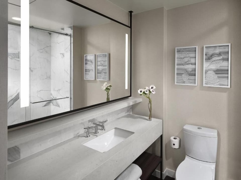 Start your day at a spacious vanity with glowing mirrors.