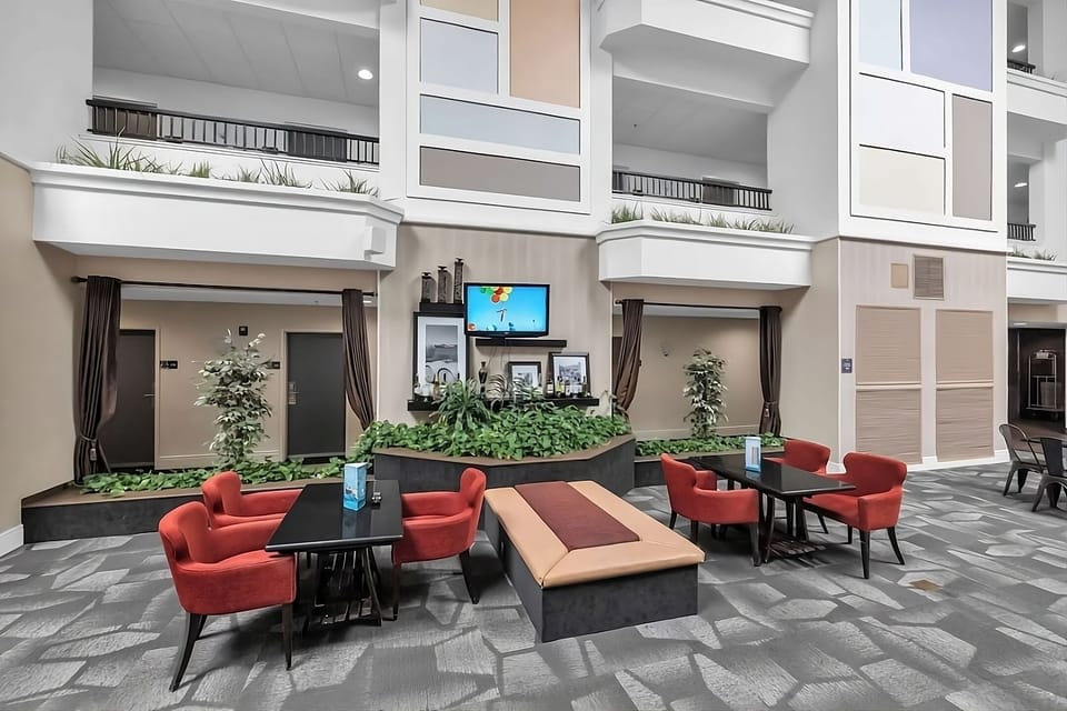 Unwind in cozy lounge seating with greenery and TV.