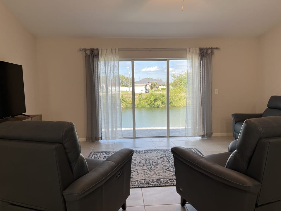 Spacious LR w the million dollar view; 65" TV, queen sleeper sofa & 2 recliners.