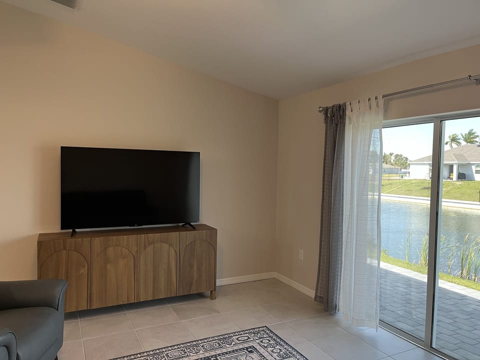Spacious LR w the million dollar view; 65" TV, queen sleeper sofa & 2 recliners.
