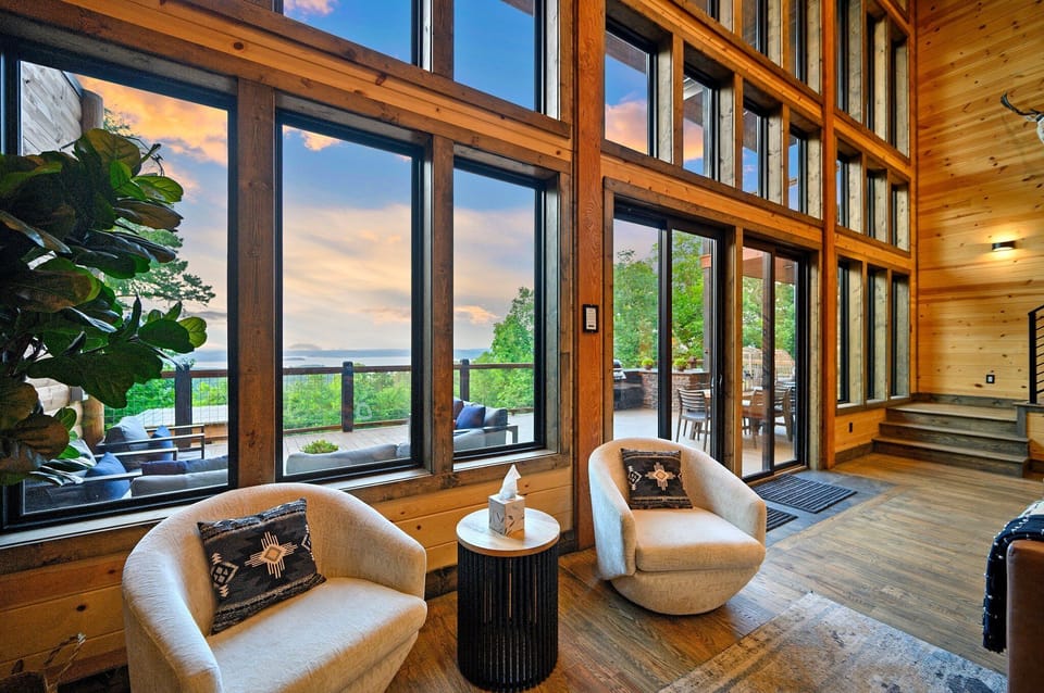 Gorgeous Living Space with swivel chairs and soaring ceilings. Huge Window Wall 