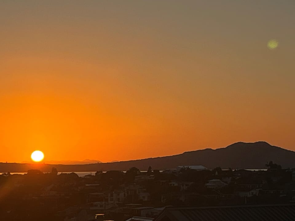 Sunrise over Rangitoto Island (volcano) from main deck & kitchen/dining/lounge 