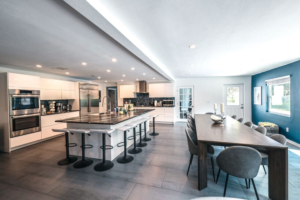 Open concept chef's kitchen and dining area seating 14 + 8