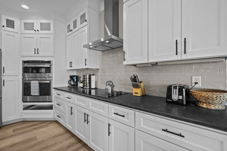 Top Level: Fully Equipped Kitchen with Ovens, Electric Cooktop, Coffee Maker, Toaster, and Essential Cooking Appliances