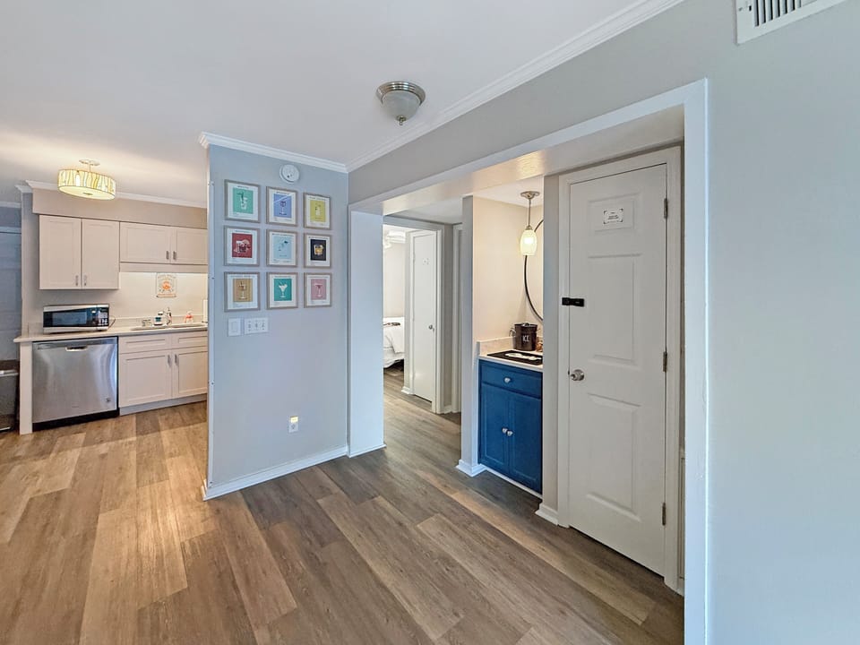 Bright open layout with modern kitchen, stainless accents, and bar nook
