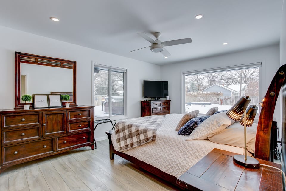 Main floor bedroom with a King bed, Smart TV and great pool view