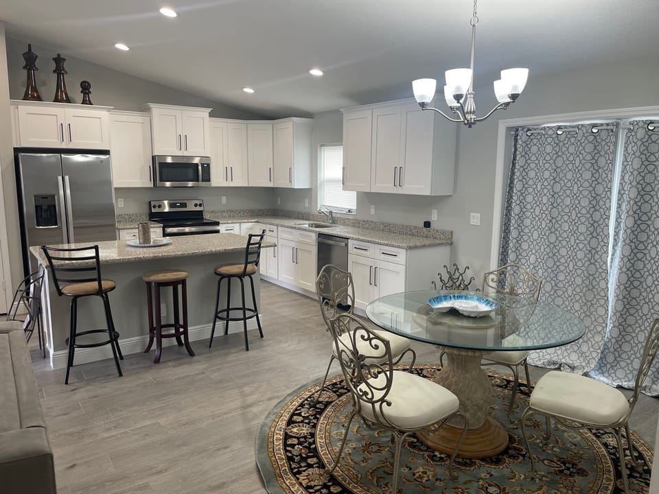 OPEN LIVING ROOM, DINING ROOM, AND KITCHEN WITH BIG BEAUTIFUL ISLAND.