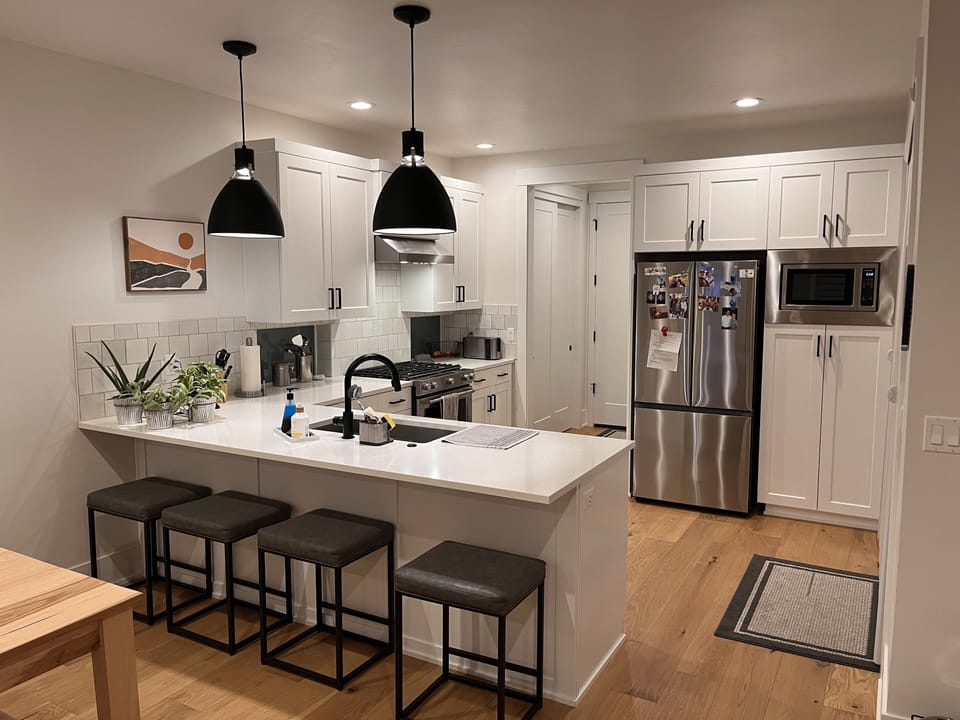 The bottom floor is an open plan that includes the living room, kitchen & dining