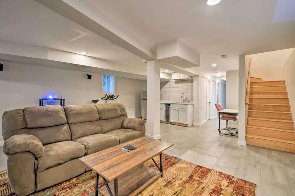 Basement living area, projector screen, workspace, kitchenette
