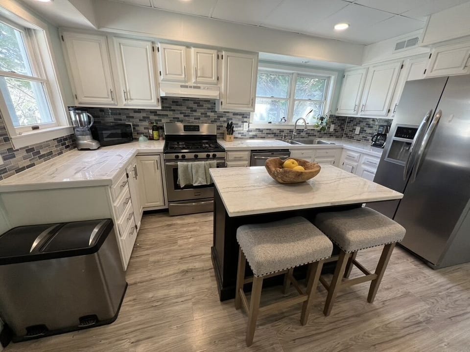 Kitchen equipped with basic needs. Bench not pictured provides ample seating. 