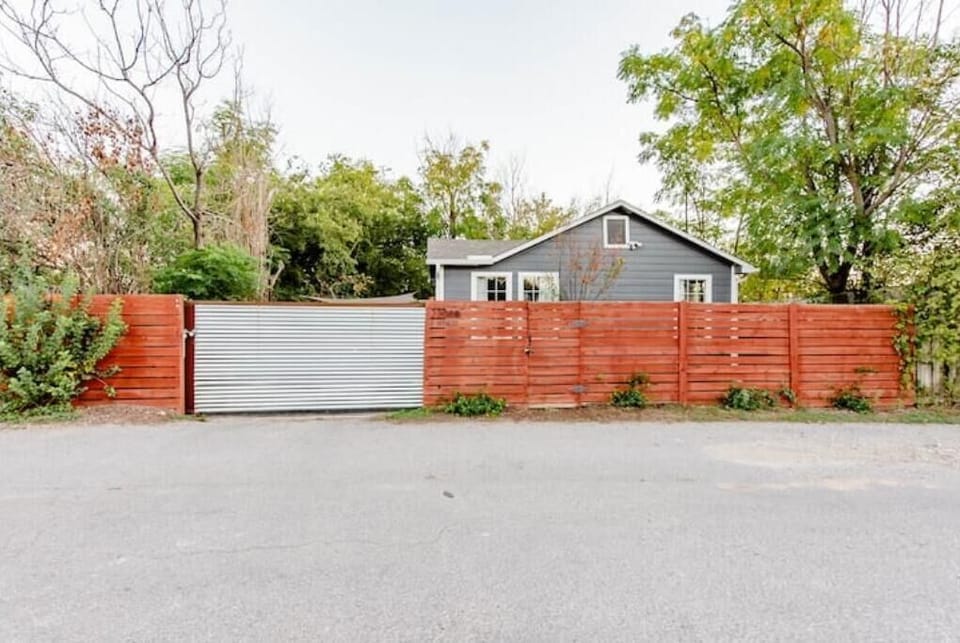 View of house from alley as you arrive, with sliding gate closed.