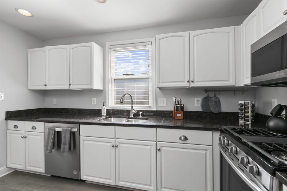 Kitchen features central window, inviting daylight to flood the space.