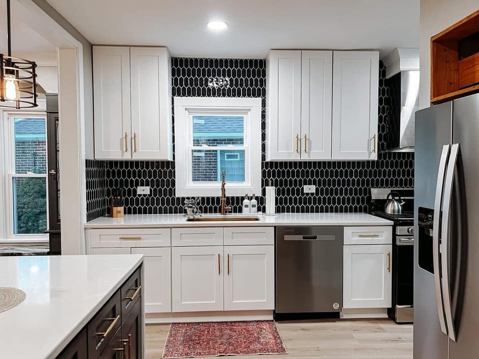 Bright kitchen w/ spacious counters, tiled backsplash & stainless appliances