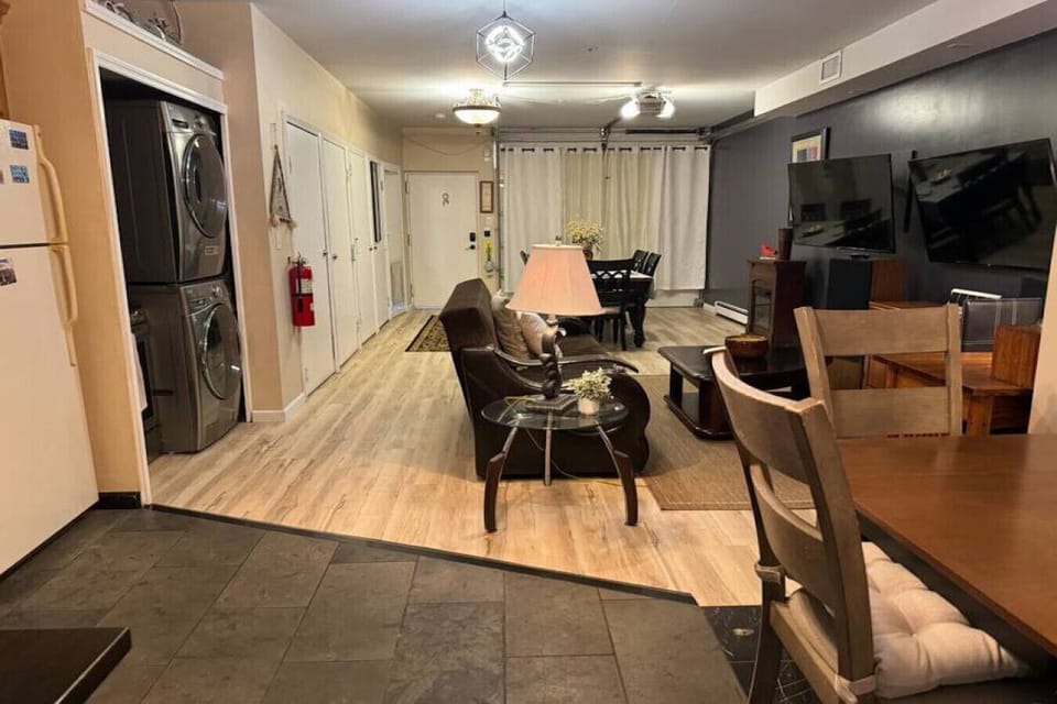Living room ground floor ; large table table, Full  pullout sofa , ceiling, fan, TV, desk – work area