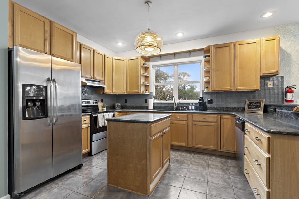 Fully stocked kitchen with stainless appliance and granite counters