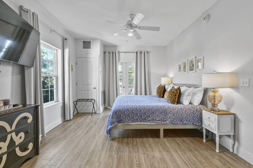 Relax in King Suite 302’s coastal-inspired bedroom, complete with luxe linens, natural light, and harbor-facing windows for a serene start to your day.