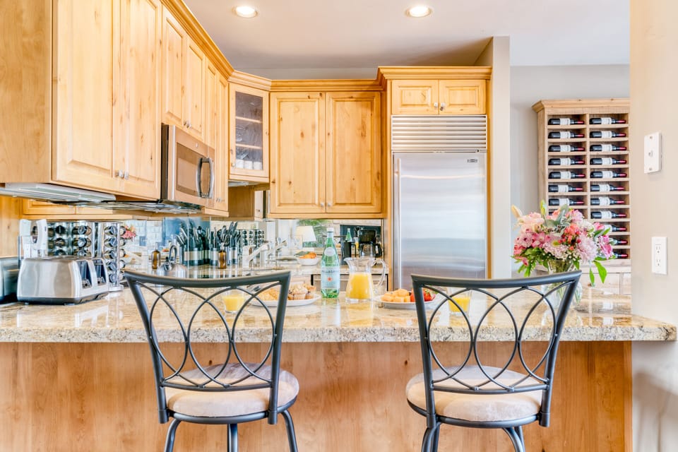 Kitchen features barstool seating.