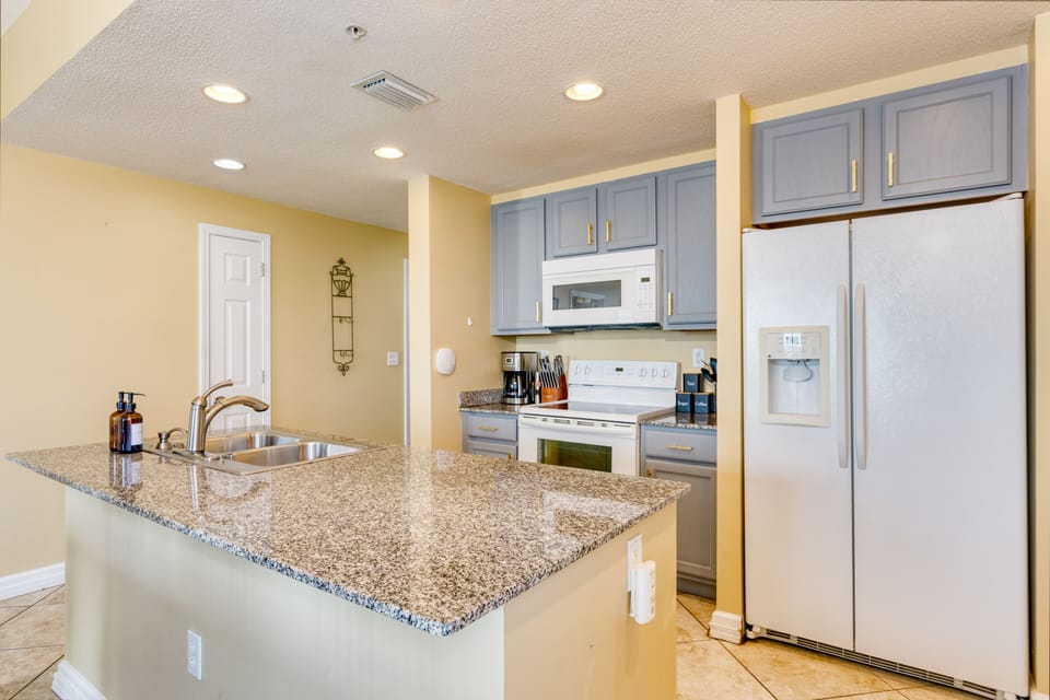Kitchen is fully equipped and features an island.