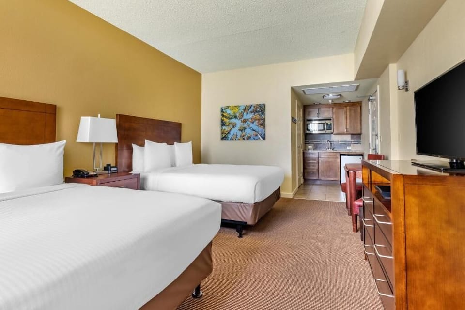 Enjoy extra convenience with in-room kitchenette beside two queen beds.