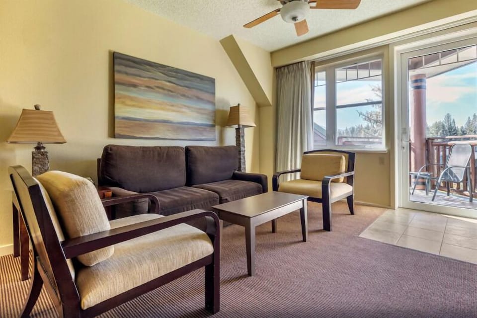 Lounge in sunlit comfort steps from the private balcony.